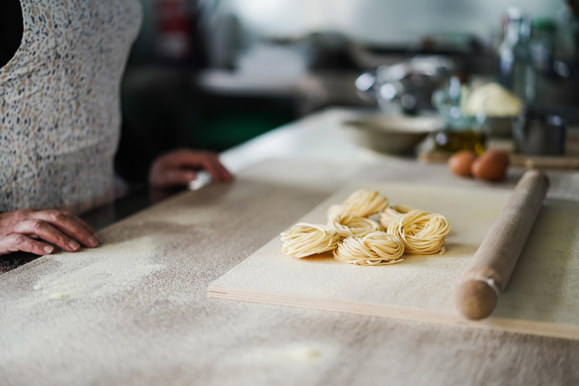 Close-up hands shaping pasta